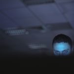 Computer Hacker Working On Laptop Late At Night In Office