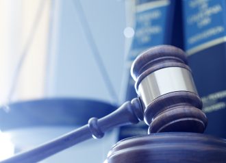 Gavel In Front Of Justice Scale And Law Books