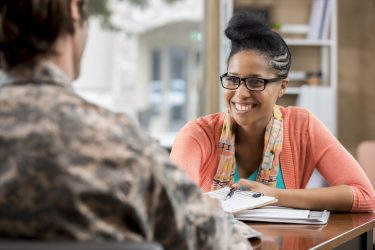 Friendly African American Female Military Counselor Talks With Veteran