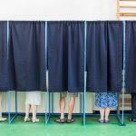People Voting In Booths